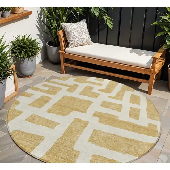 8' Gold And Ivory Round Abstract Washable Indoor Outdoor Area Rug Photo 1