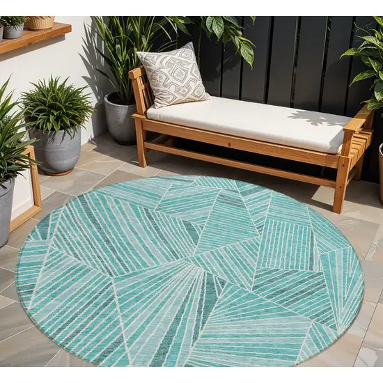 8' Teal Blue And Ivory Round Geometric Washable Indoor Outdoor Area Rug Photo 1