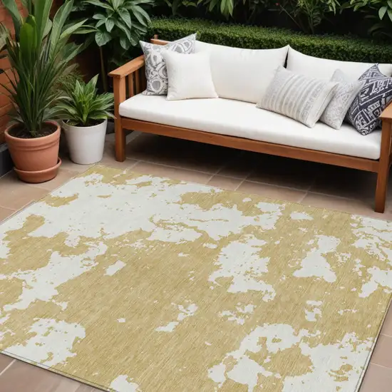 Gold And Ivory Abstract Washable Indoor Outdoor Area Rug Photo 1