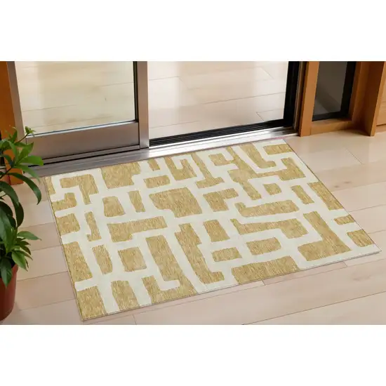 Gold And Ivory Abstract Washable Indoor Outdoor Area Rug Photo 1