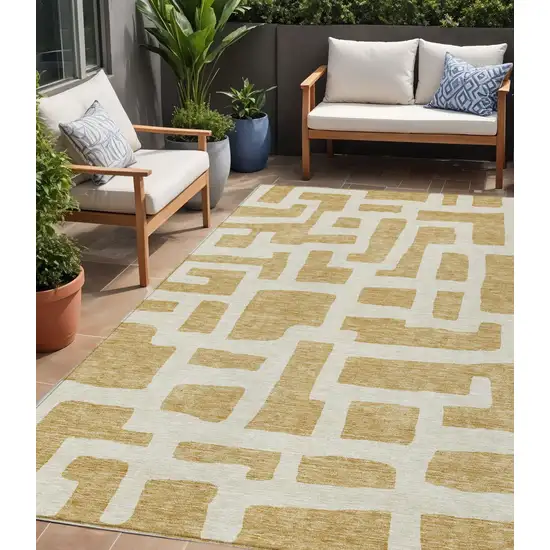 Gold And Ivory Abstract Washable Indoor Outdoor Area Rug Photo 1