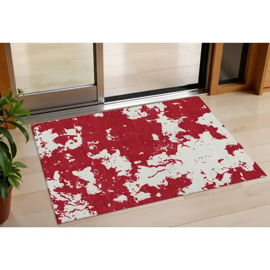Red And Ivory Abstract Washable Indoor Outdoor Area Rug Photo 1