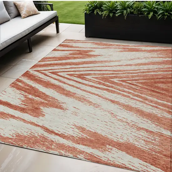 Salmon And Ivory Abstract Washable Indoor Outdoor Area Rug Photo 1