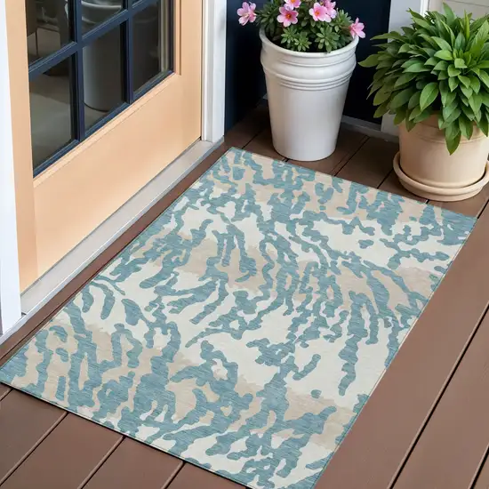Teal Blue Beige And Ivory Animal Print Washable Indoor Outdoor Area Rug Photo 1